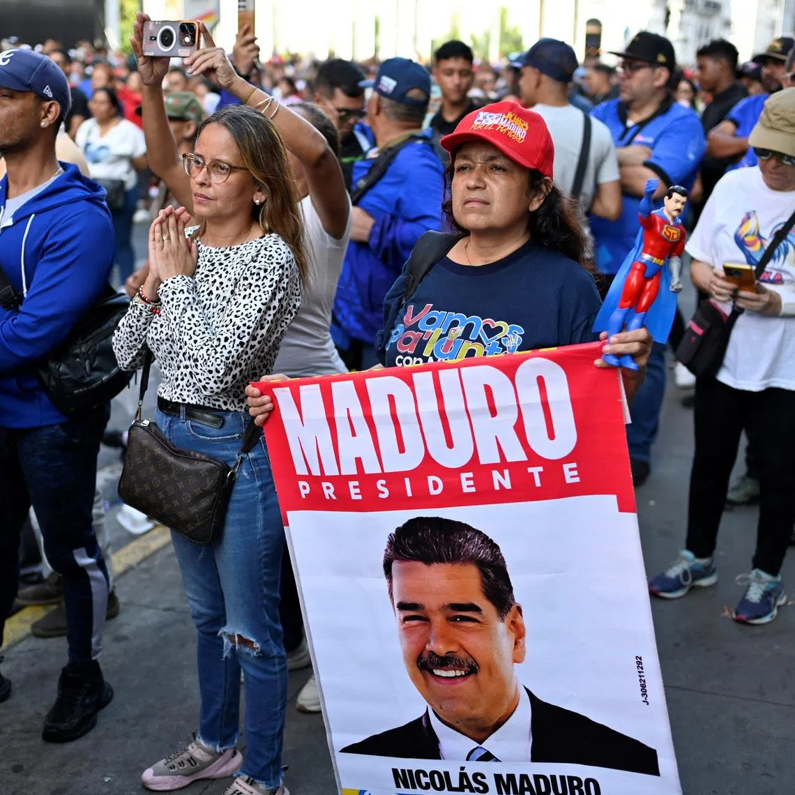 A demonstrator with an image of Venezuelan President Nicolas Maduro during a march outside the National Assembly in Caracas, Venezuela, on Jan 5.