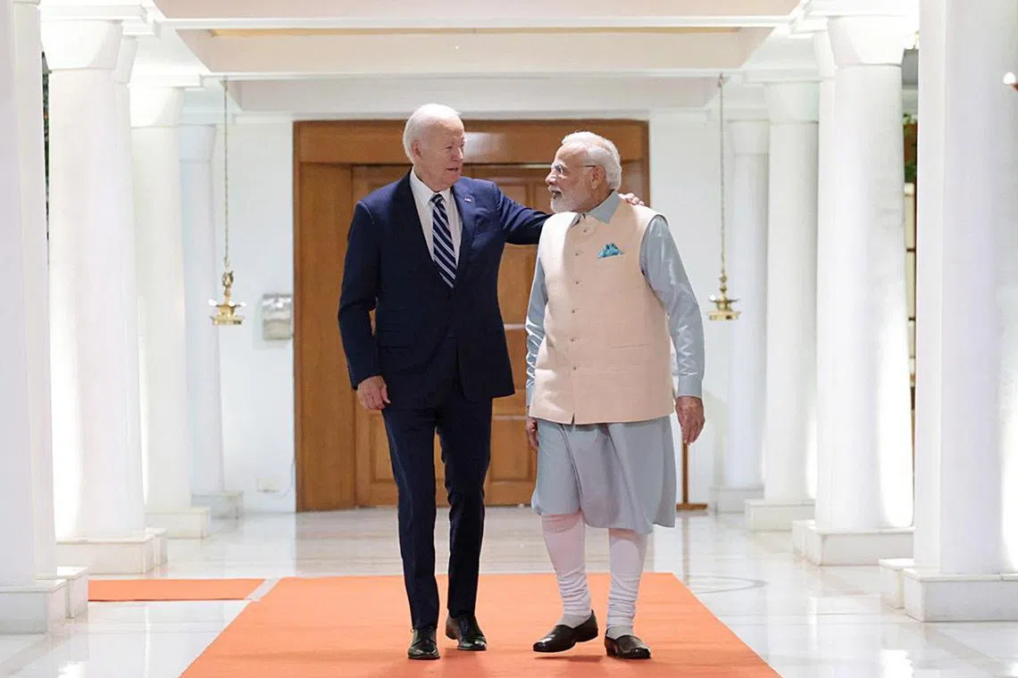 A handout photo shows Indian Prime Minister Narendra Modi (right) welcoming US President Joe Biden in New Delhi.