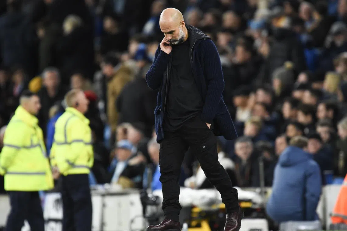 Manchester City manager Pep Guardiola reacts after losing the match against Manchester United.