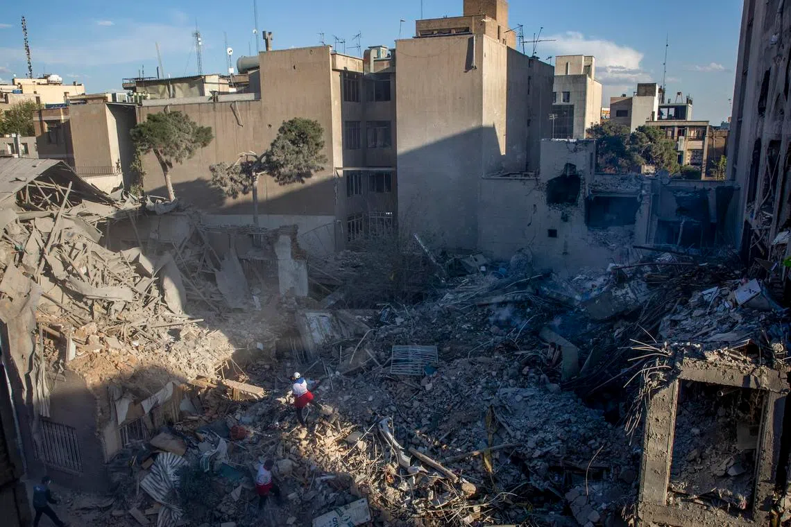 Red Crescent Society workers clear debris from a synagogue destroyed in US-Israeli airstrikes in Tehran on April 7.