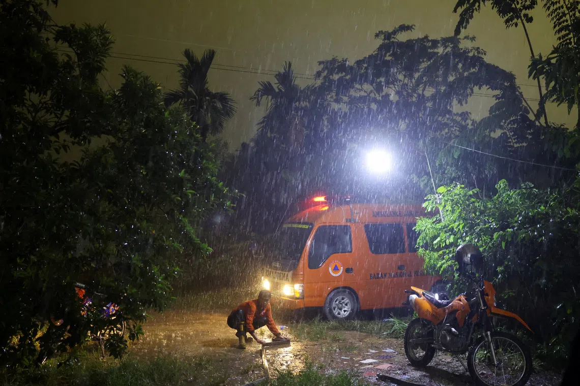 A staff member of the Regional Disaster Agency (BPBD) rolls a hose after extinguishing a fire in a peatland area burnt by wildfires, during heavy rains, in Kubu Raya, West Kalimantan province, Indonesia, September 15, 2026. REUTERS/Ajeng Dinar Ulfiana TPX IMAGES OF THE DAY