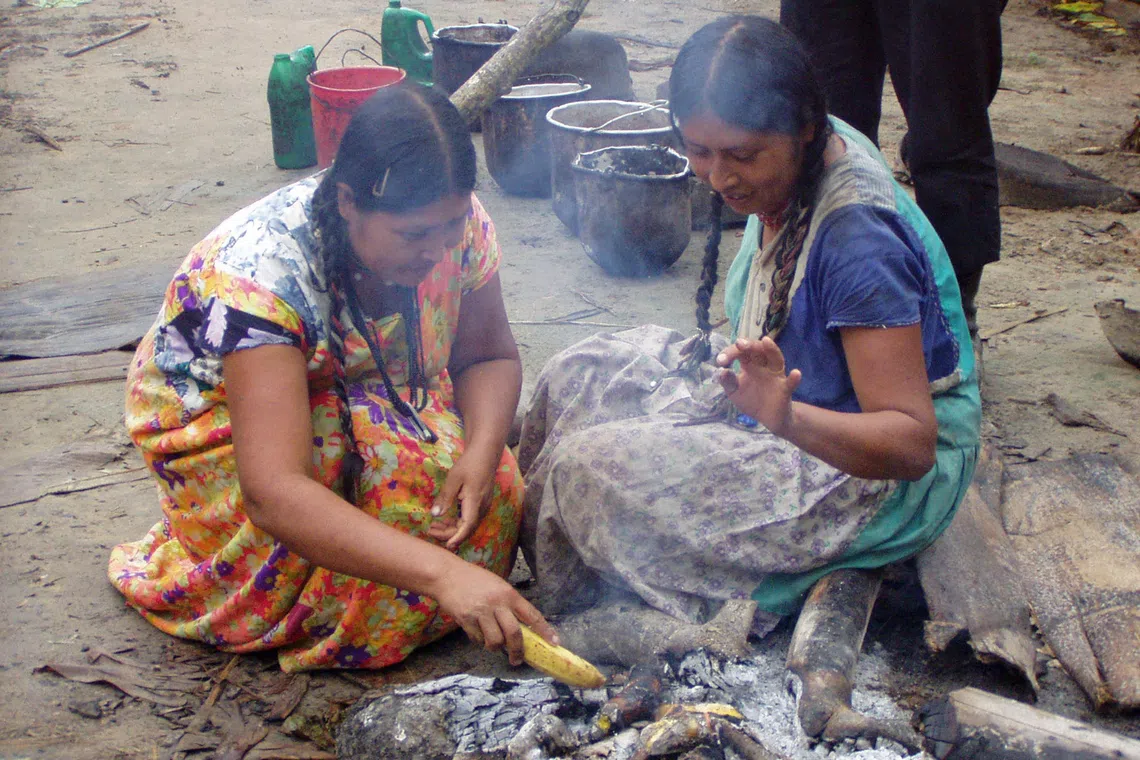 Tsimane women cook breakfast in the Bolivian Amazon in an undated image.