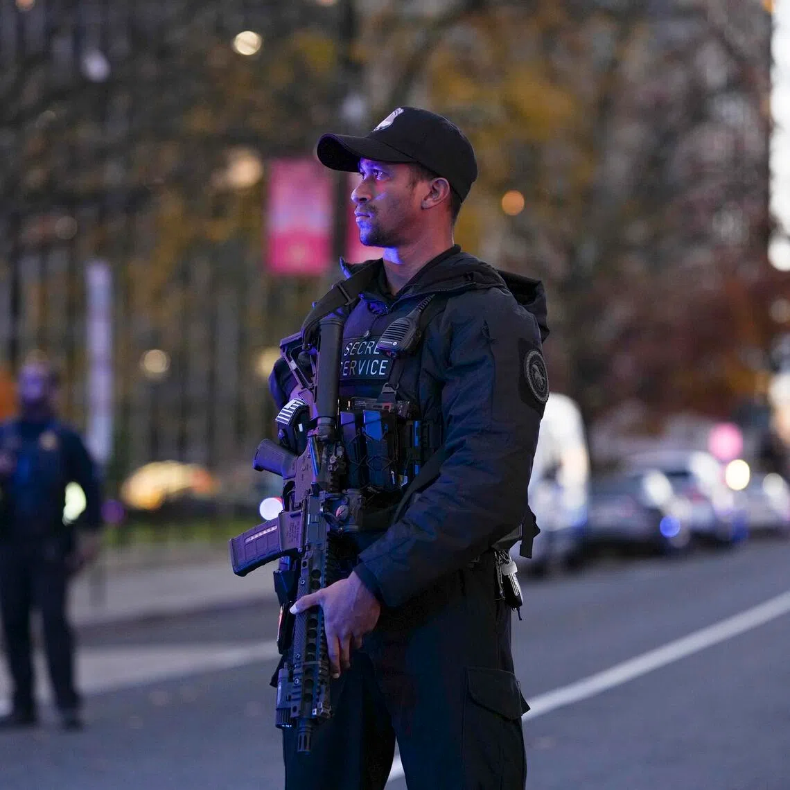 Law enforcers stand near where two National Guard soldiers were shot in Washington on Nov. 26, 2025.
