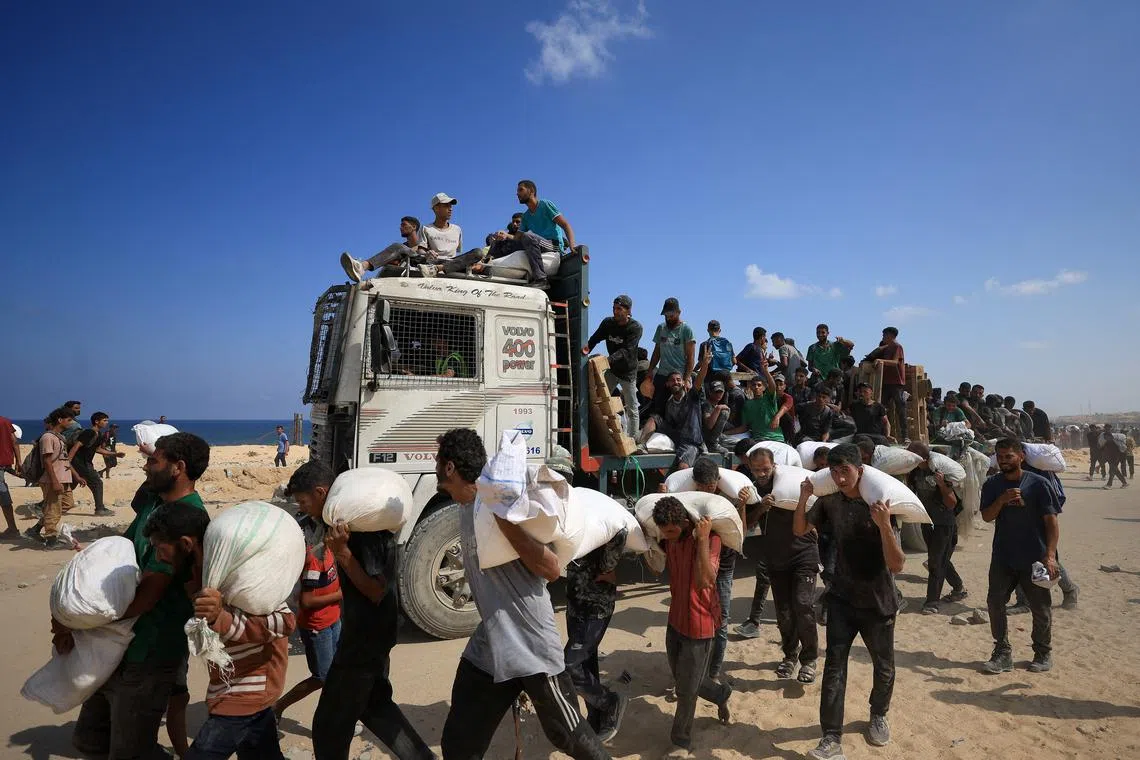 Palestinians carrying aid supplies that entered Gaza through Israel on July 20.
