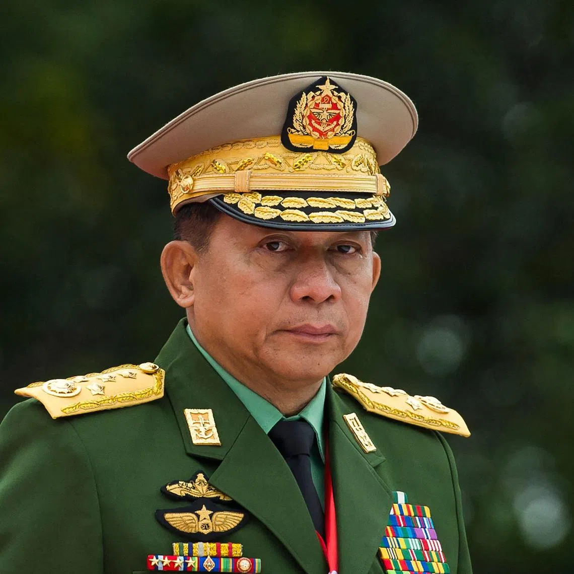 (FILES) Myanmar's Chief Senior General Min Aung Hlaing, commander-in-chief of the Myanmar armed forces, arrives for a ceremony to mark the 71th anniversary of Martyrs' Day in Yangon on July 19, 2018. Myanmar's military on August 14, 2024 said rumours top generals had detained the embattled junta chief in a new coup were "propaganda" spread by "traitors" ahead of a vist by China's foreign minister. (Photo by YE AUNG THU / AFP)