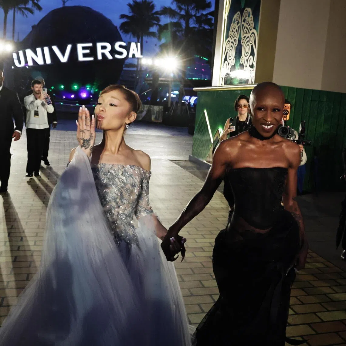 Ariana Grande (left) and Cynthia Erivo arrive for the premiere of Wicked: For Good in Universal Studios Singapore on Nov 13, 2025.
