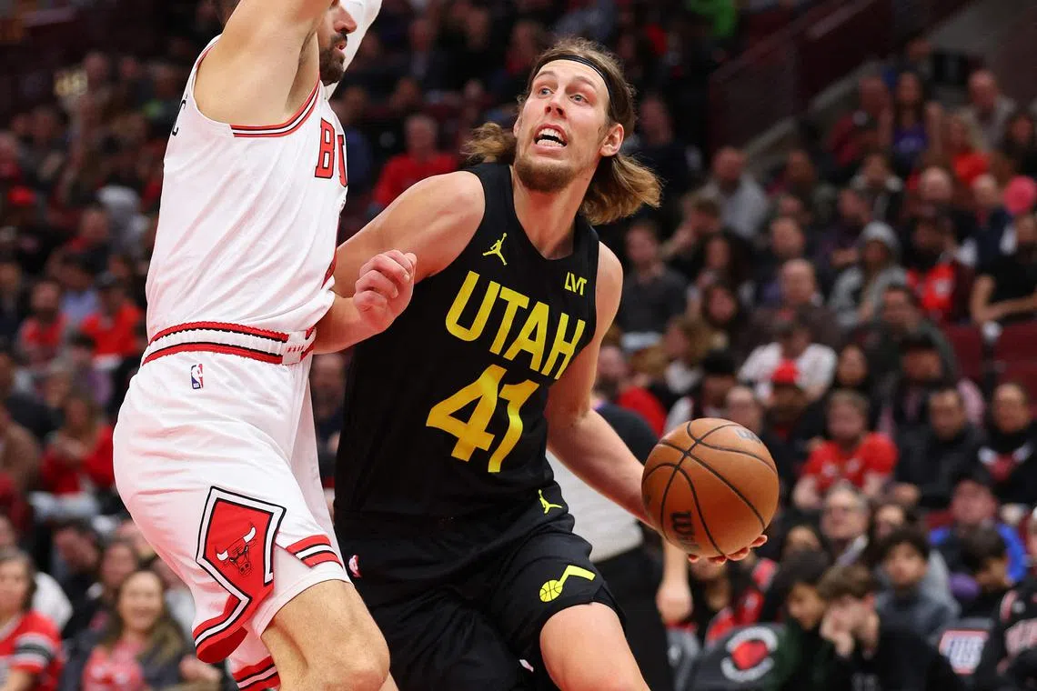 Kelly Olynyk of the Utah Jazz drives to the basket against Nikola Vucevic of the Chicago Bulls.