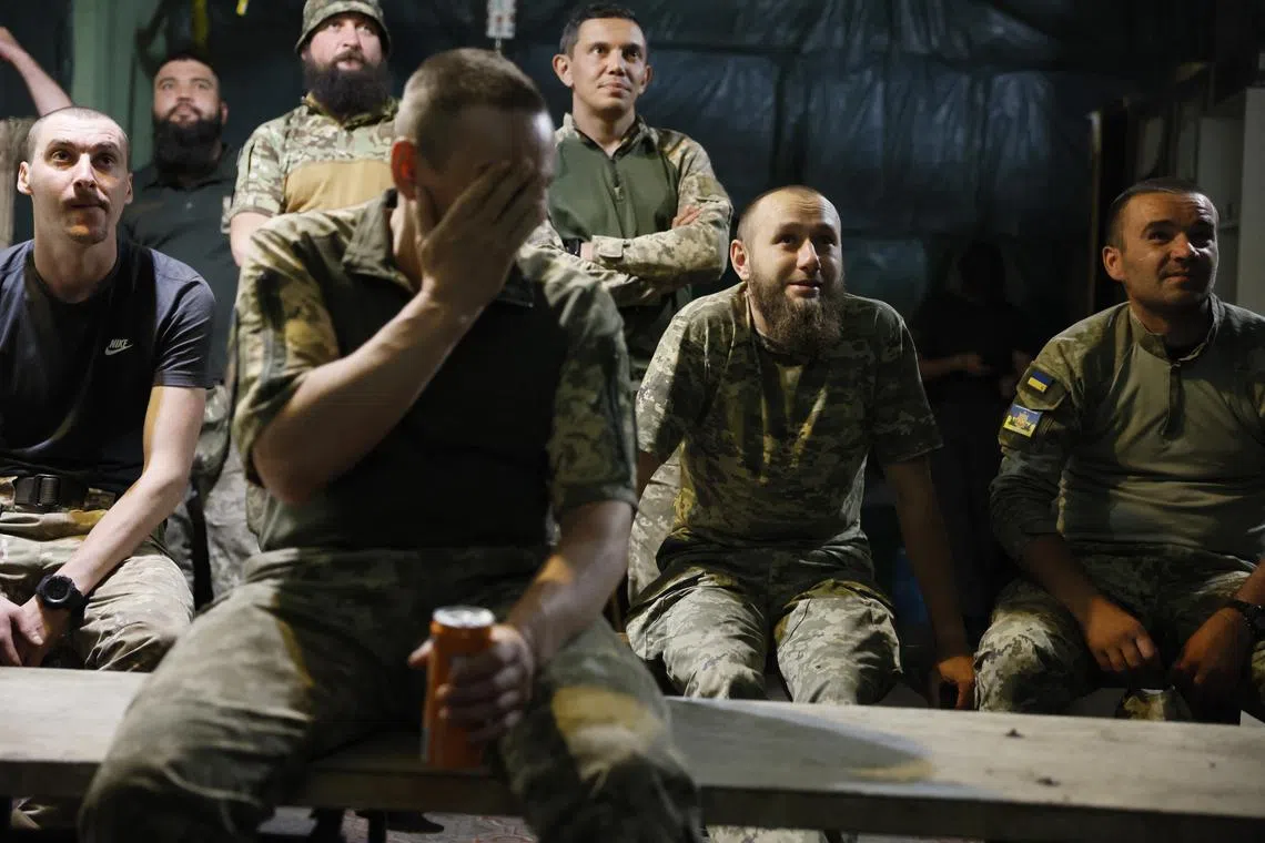 Soccer Football - Euro 2024 - Soldiers in Donetsk region gather for Ukraine v Belgium - Donetsk region, Ukraine - June 26, 2024 Ukrainian service members of the 3rd Luhansk Border Detachment react after watching the match as Ukraine were eliminated from the tournament REUTERS/Alina Smutko