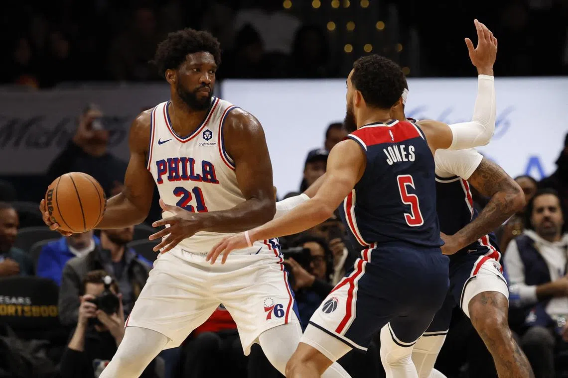 Philadelphia 76ers centre Joel Embiid holds the ball as Washington Wizards guard Tyus Jones defends in the third quarter at Capital One Arena.