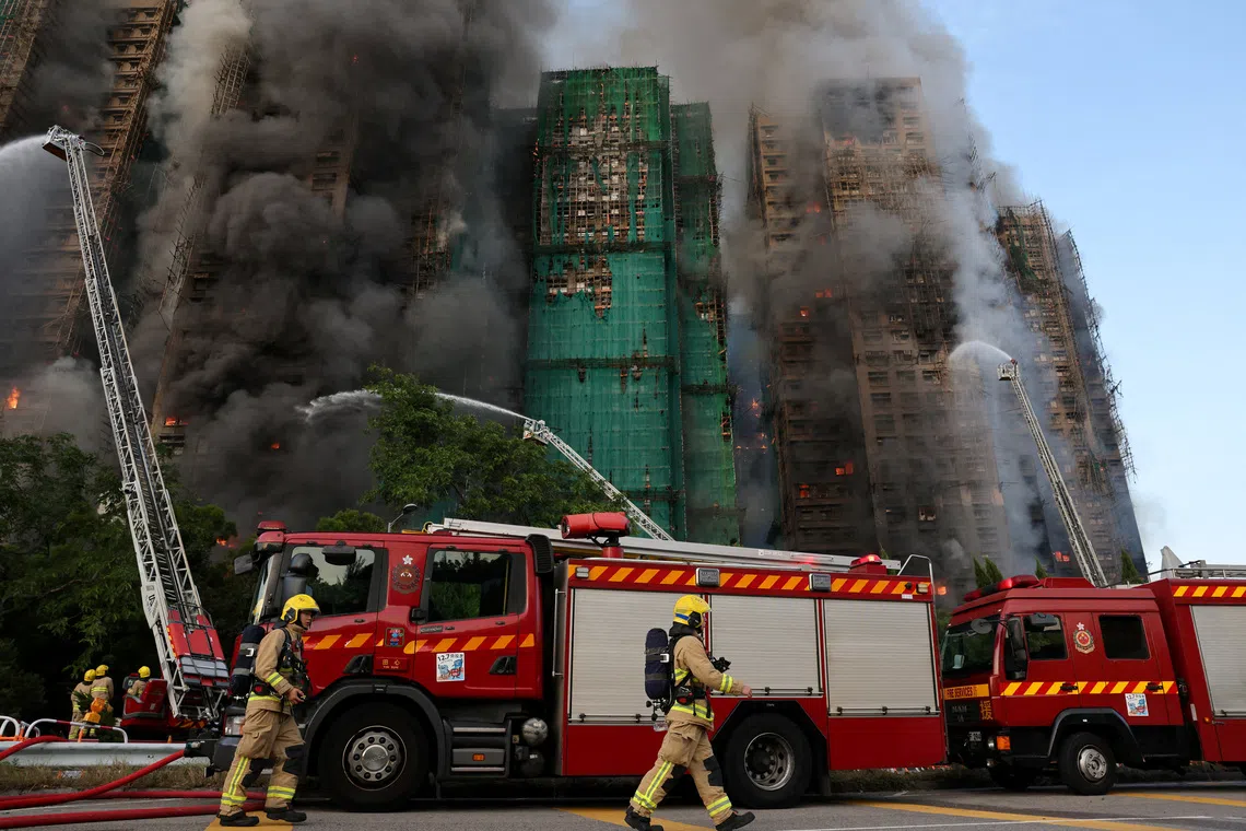 Firefighters work as efforts are underway to extinguish flames engulfing bamboo scaffolding across multiple buildings at the Wang Fuk Court housing estate in Tai Po, Hong Kong, China, November 26, 2025. REUTERS/Tyrone Siu     TPX IMAGES OF THE DAY