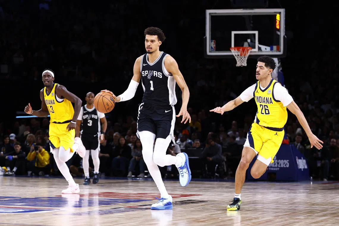 San Antonio Spurs' Victor Wembanyama in action with Indiana Pacers' Ben Sheppard in Paris.