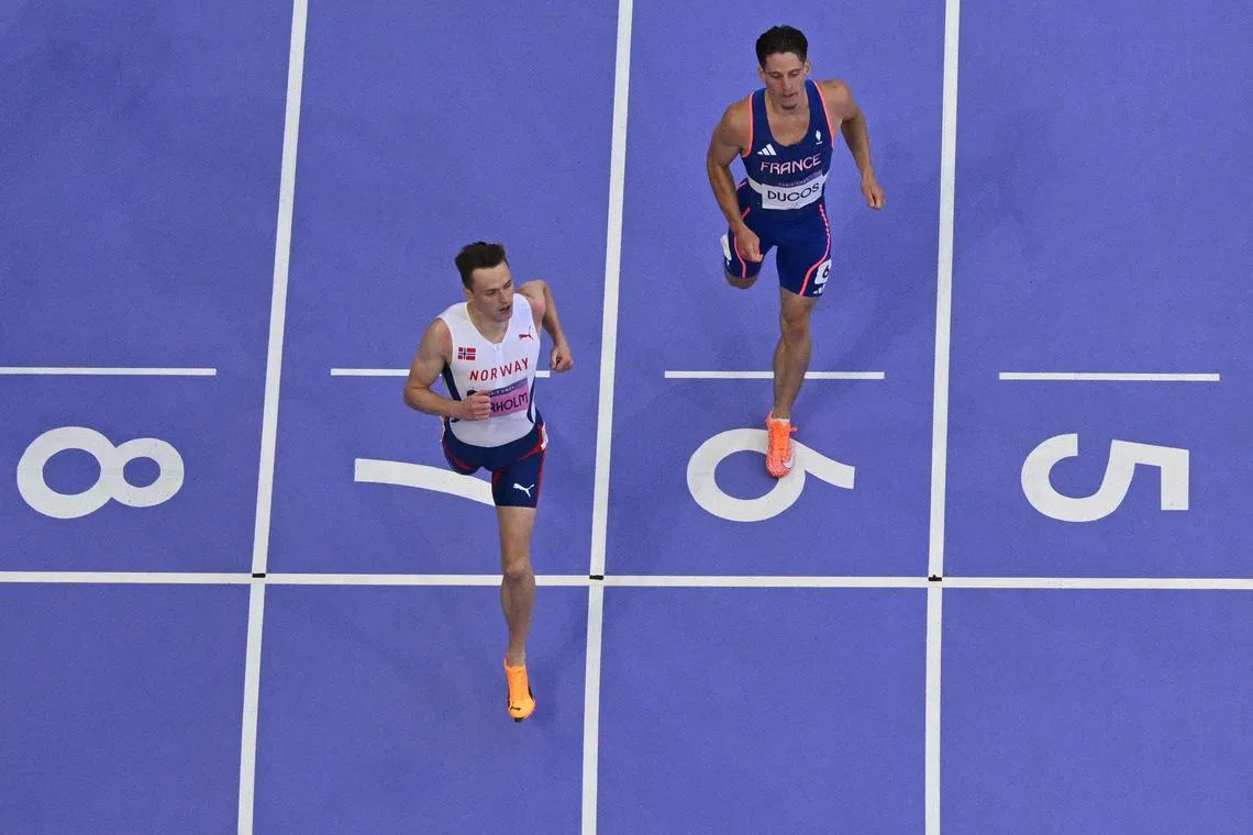 Norway's Karsten Warholm and France's Clement Ducos crossing the finish line in the men's 400m hurdles semi-final 1 at the Paris Olympic Games at Stade de France  on Aug 7, 2024.