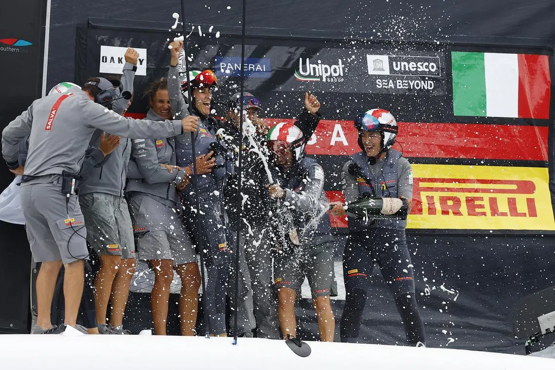 Sailing - Women's America's Cup - Puig Women's America's Cup Match Race Final - Britain v Italy - Barcelona, Spain - October 12, 2024 Luna Rossa Prada Pirelli crew celebrate with champagne after winning the Puig Women's America's Cup REUTERS/Albert Gea