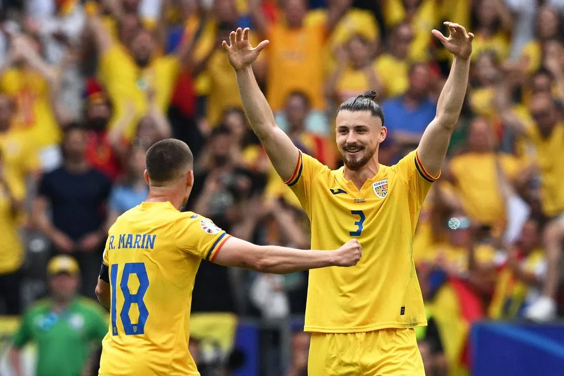 FILE PHOTO: Soccer Football - Euro 2024 - Group E - Romania v Ukraine - Munich Football Arena, Munich, Germany - June 17, 2024 Romania's Radu Dragusin and Razvan Marin celebrate after the match REUTERS/Angelika Warmuth/File Photo