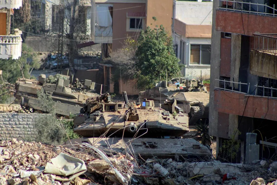 Israeli armoured vehicles at the entrance of Lebanese village of Aitaroun on Jan 29.