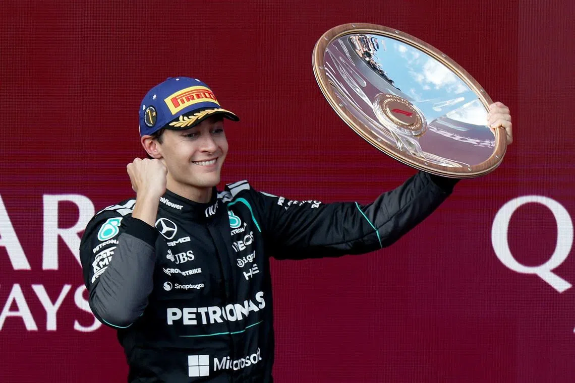 Formula One F1 - Australian Grand Prix - Albert Park Grand Prix Circuit, Melbourne, Australia - March 8, 2026 Mercedes' George Russell celebrates with the trophy on the podium after winning the Australian Grand Prix REUTERS/Hollie Adams