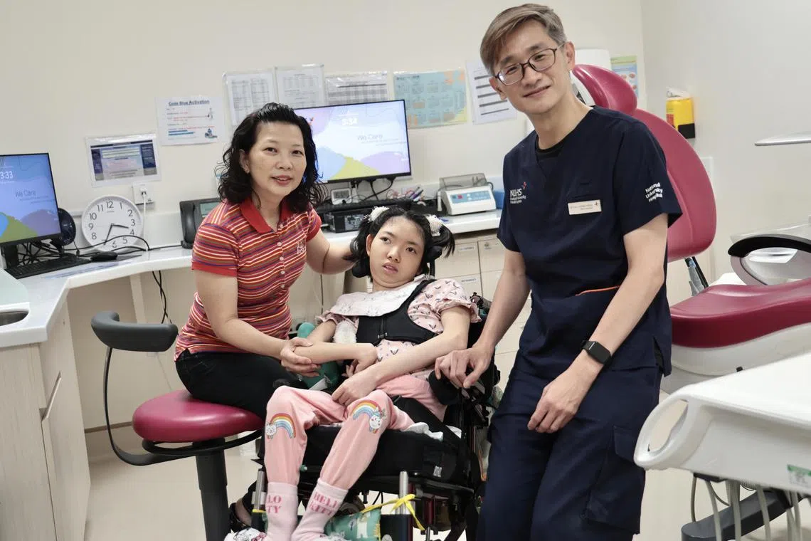 Cerebral palsy patient Hillary Chua with her mother Cindy Wong and Dr Tay Chong Meng, division head of advanced general dental practice at the National University Centre for Oral Health Singapore.