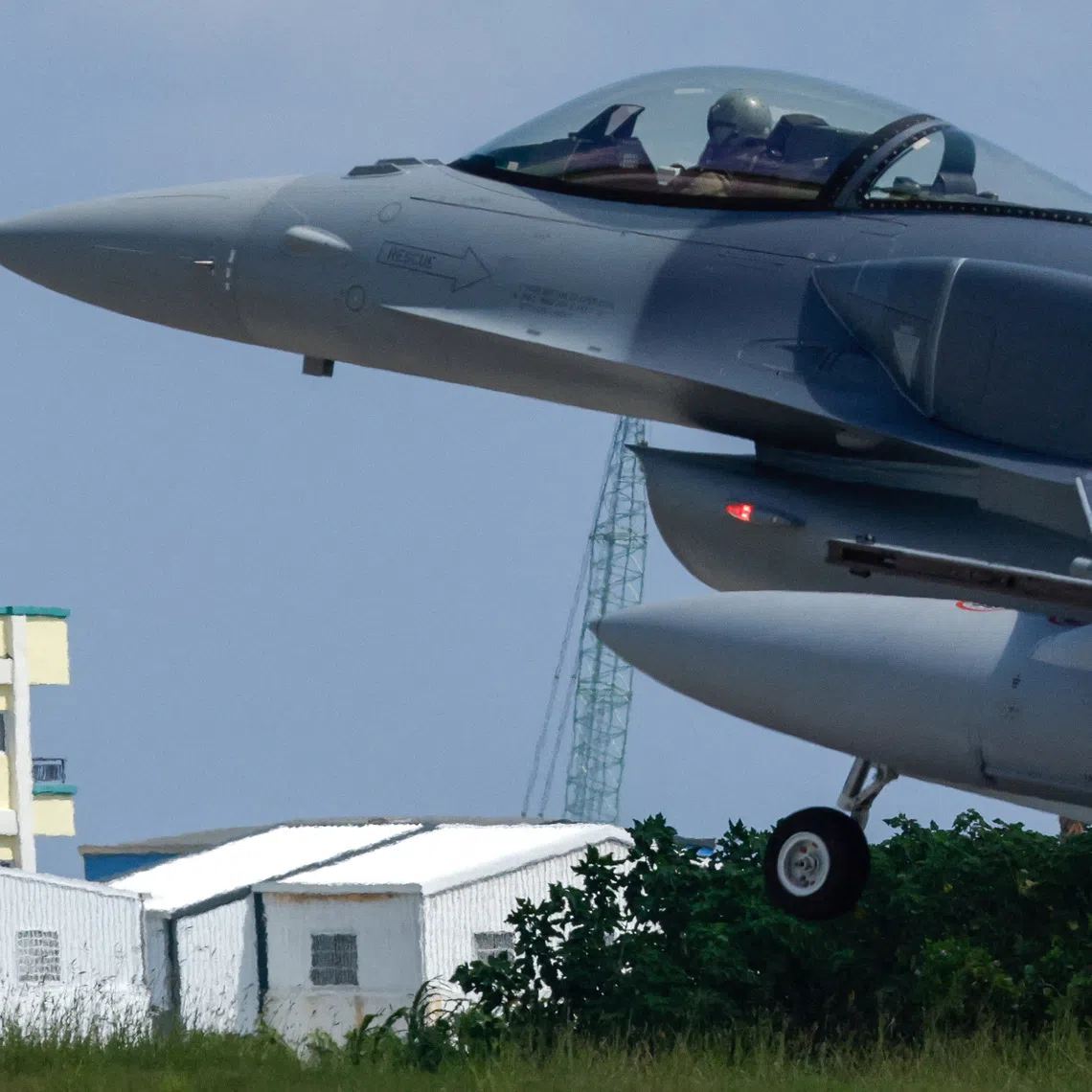 A Lockheed Martin F-16V fighter jet lands at Taitung’s Chihhang Air Base as people watch from a nearby hotel in Taitung, Taiwan, on Oct 2.
