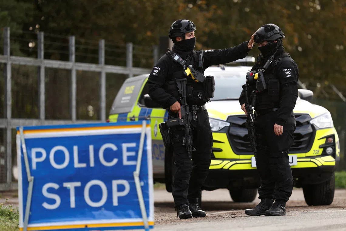Armed police officers work on a road outside the perimeter of the RAF Fairford airbase, after police declared a major incident at the base after several men were arrested on suspicion of offences under the Explosives Act, in Fairford, Gloucestershire, Britain, September 28, 2026. REUTERS/Toby Shepheard