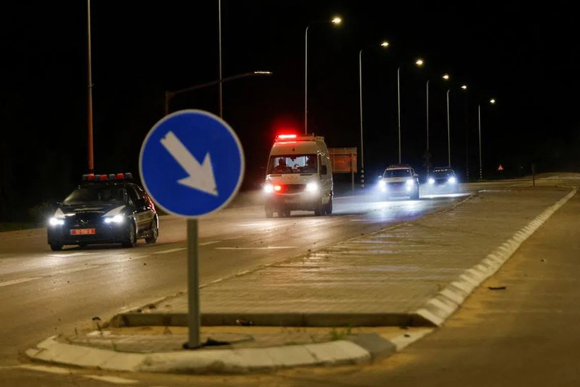 An ambulance believed to be carrying hostages released as part of a deal between Israel and Palestinian Islamist group Hamas, drives near the Israel-Gaza border, in Israel November 26, 2023. REUTERS/Amir Cohen