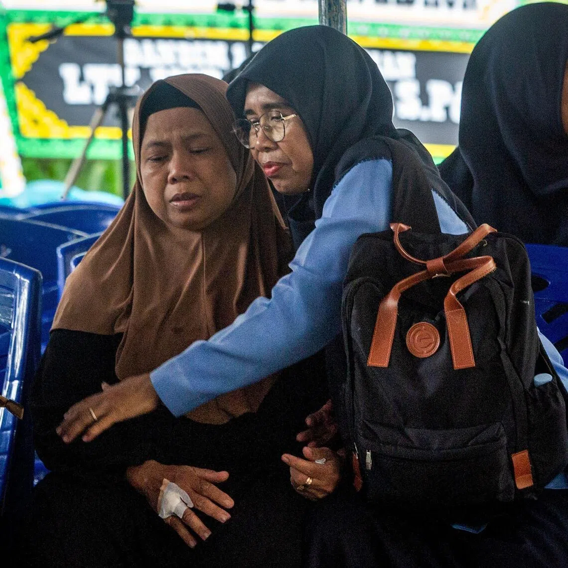 The mother of Indonesian soldier Farizal Rhomadhon, a United Nations Interim Force in Lebanon (UNIFIL) personnel who was killed in Lebanon, is comforted a day after his death at her home in Yogyakarta on March 31, 2026.