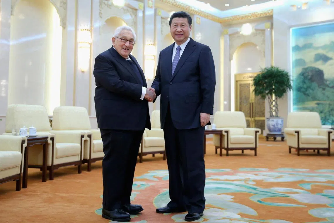 (FILES) Chinese President Xi Jinping (R) shakes hands with Former US Secretary of State Henry Kissinger at the Great Hall of the People in Beijing on March 17, 2015. Former US secretary of state Henry Kissinger, a key figure of American diplomacy in the post-World War II era, died November 29, 2023 at the age of 100, his association said. (Photo by FENG LI / POOL / AFP)