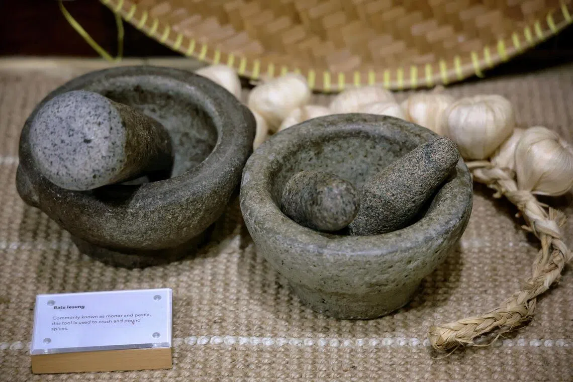 Batu lesung or mortar and pestle are some of the cooking tools on display at the Museum Of Food in Joo Chiat.