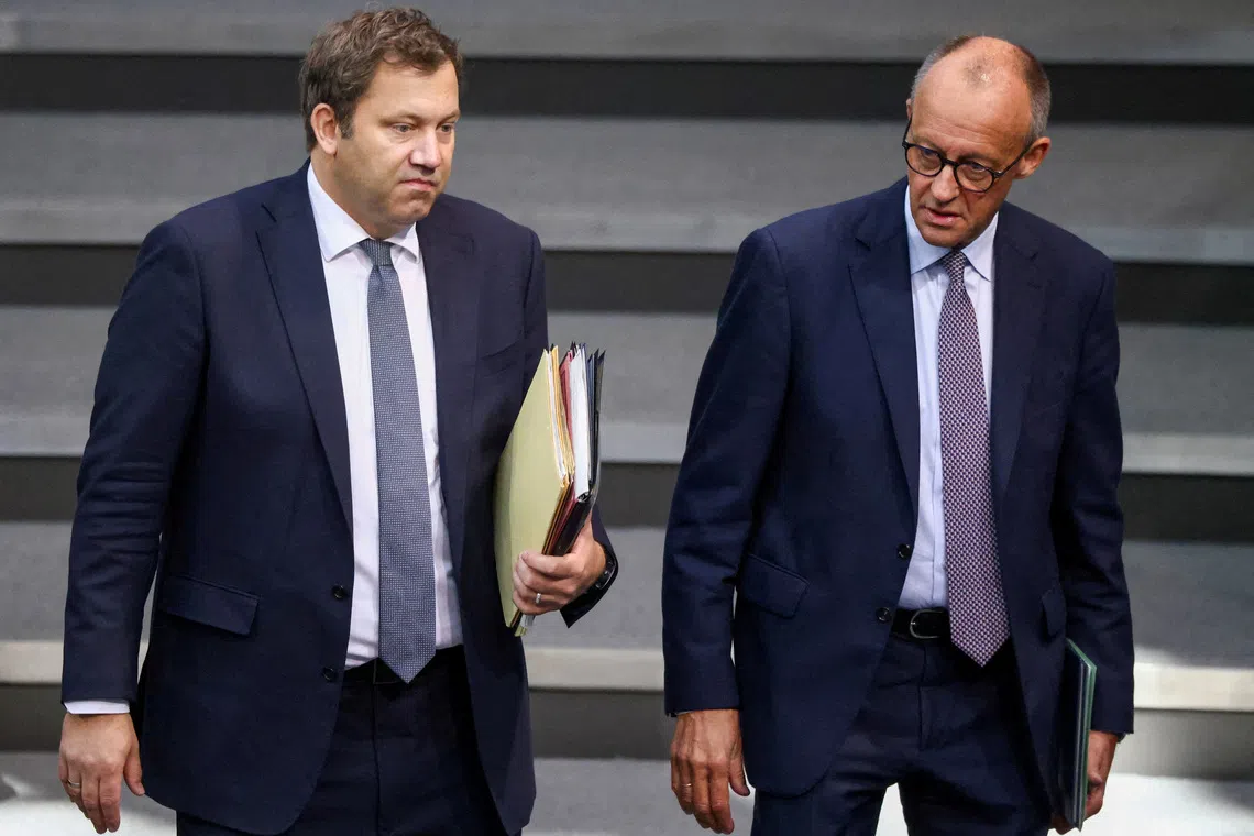 FILE PHOTO: German Chancellor Friedrich Merz and Vice Chancellor and Finance Minister Lars Klingbeil arrive for the annual budget debate at the Bundestag, in Berlin, Germany, September 24, 2025. REUTERS/Liesa Johannssen/File Photo