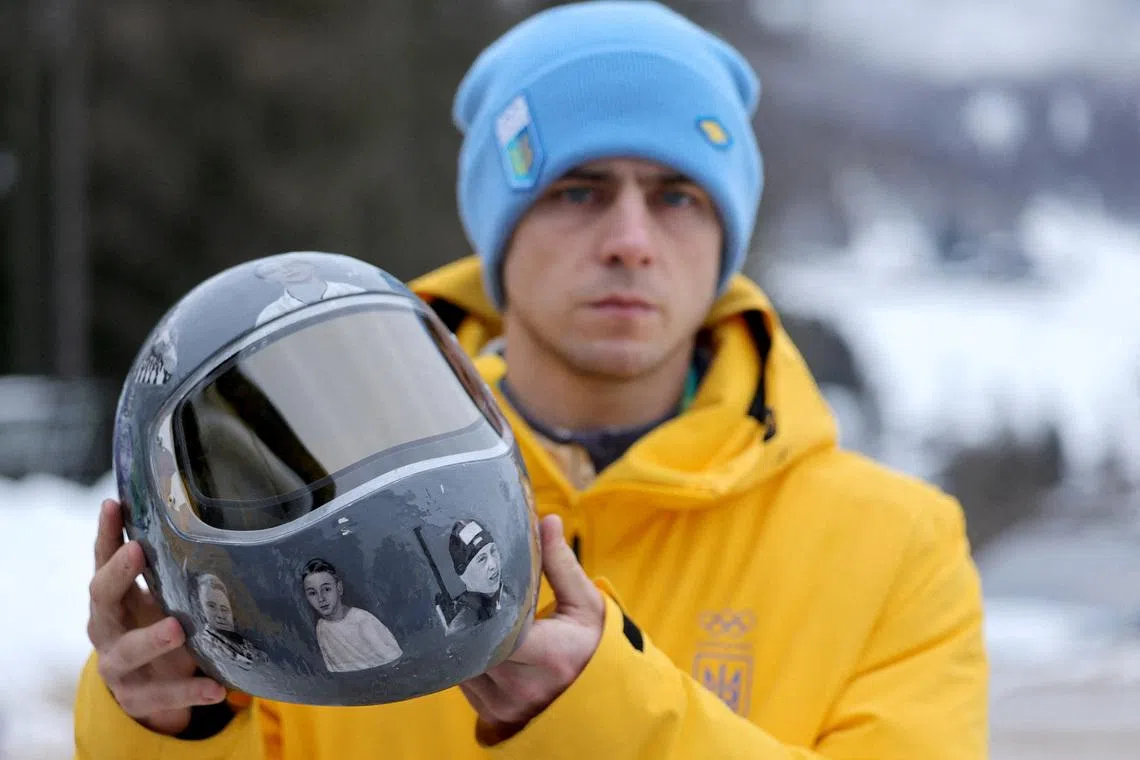 Milano Cortina 2026 Olympics - Skeleton - IOC President Kirsty Coventry meets skeleton racer Vladyslav Heraskevych of Ukraine - Cortina Sliding Centre, Cortina d'Ampezzo, Italy - February 12, 2026. Vladyslav Heraskevych of Ukraine shows his helmet following his disqualification from Olympic competition for wearing it in tribute to athletes who have died amid Russia's attack on Ukraine after a scheduled meeting with IOC President Kirsty Coventry REUTERS/Athit Perawongmetha