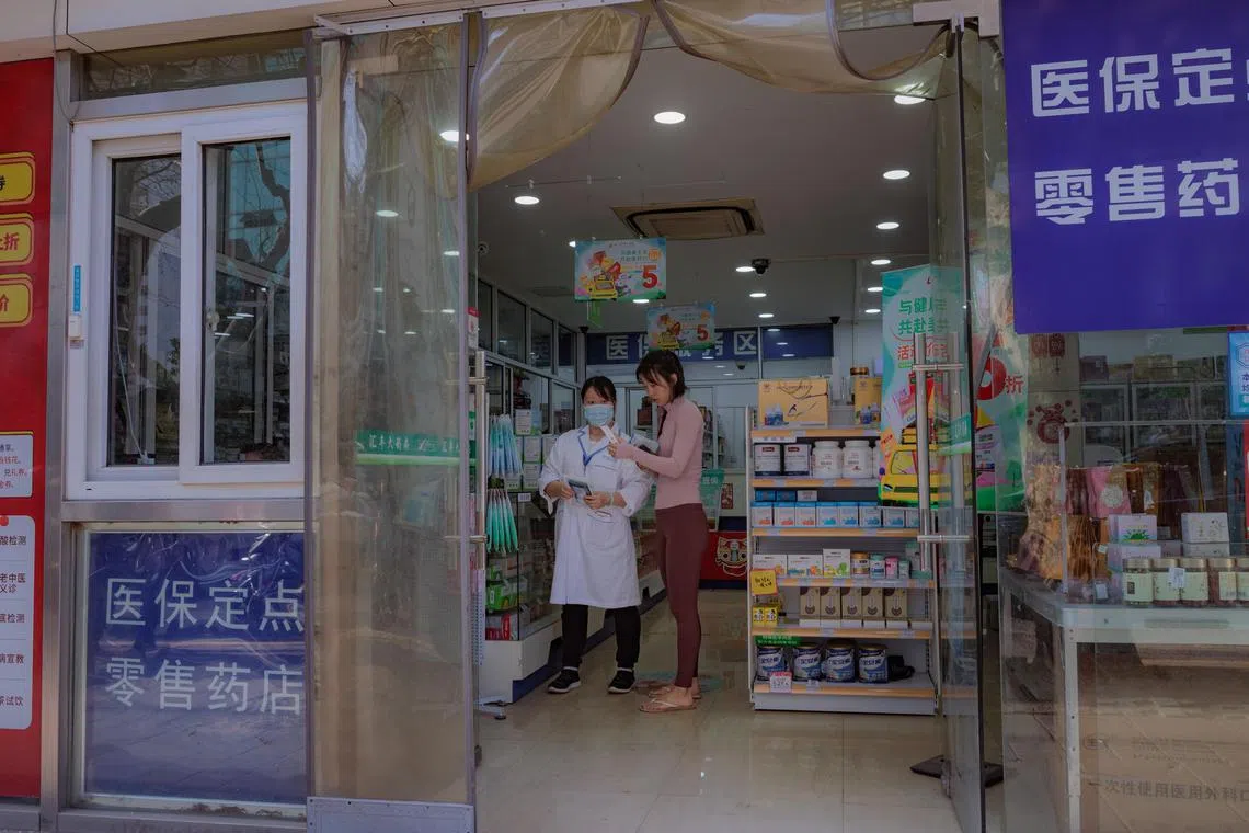 epa10513291 A woman buys medicines at a pharmacy in Shanghai, China, 10 March 2023. Authorities from China's Xi'an city, the capital of the Shaanxi province, published an emergency notice earlier in the week alerting of the potential suspension of business activities and schools over a surge in H1N1 influenza cases across the country. The emergency plan may include temporary lockdowns, the enforcement of quarantine measures, and work and production suspensions in the affected areas, depending on the severity of the outbreak.  EPA-EFE/ALEX PLAVEVSKI