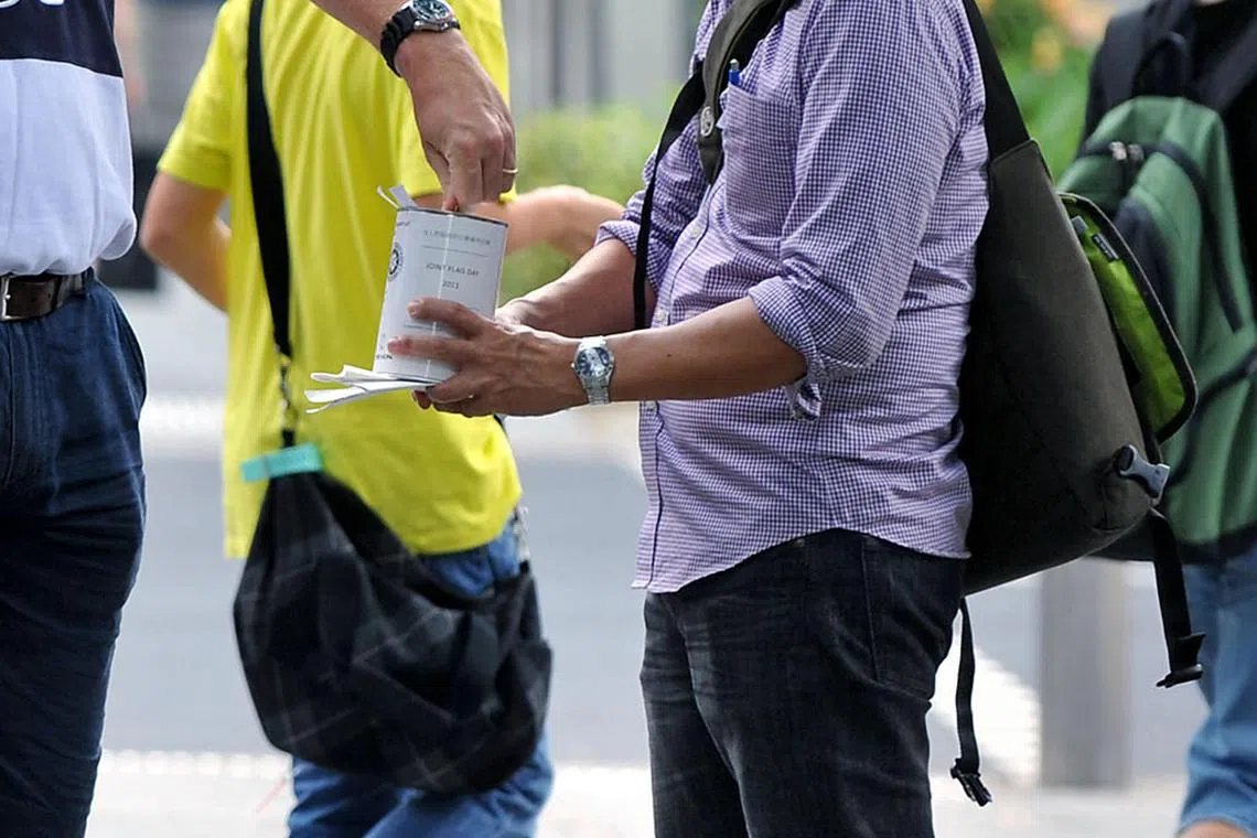 Collecting donations as part of a flag day event for the charity Hope worldwide (Singapore) and St John Ambulance on 19 March 2011.
 