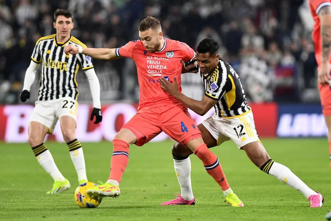 Soccer Football - Serie A - Juventus v Udinese - Allianz Stadium, Turin, Italy - February 12, 2024 Udinese's Sandi Lovric in action with Juventus' Alex Sandro REUTERS/Massimo Pinca