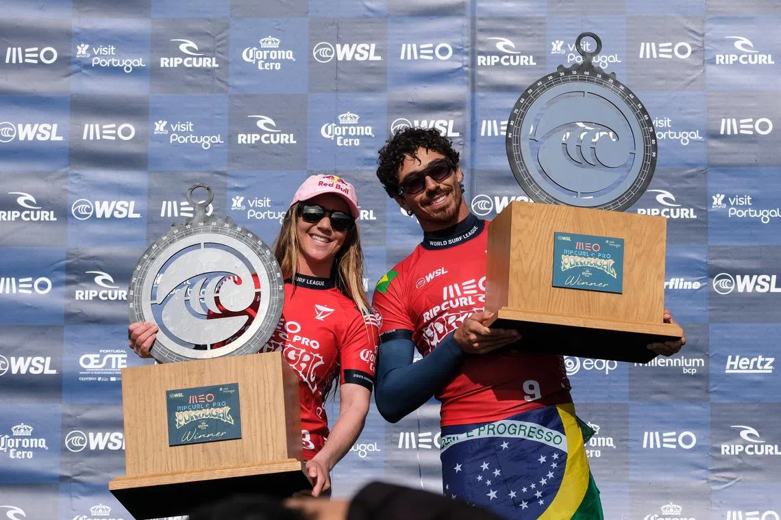 American Caroline Marks and Brazilian Yago Dora celebrate on the podium after winning the third stage of the World Surfing Championships at Super Tubos beach, in Peniche, Portugal on March 23, 2025.