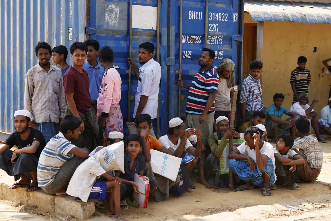 FILE PHOTO: Rohingya refugees wait for relief supplies during Ramadan, at the Rohingya refugee camp in Cox's Bazar, Bangladesh, March 16, 2025. REUTERS/Mohammad Ponir Hossain/File photo