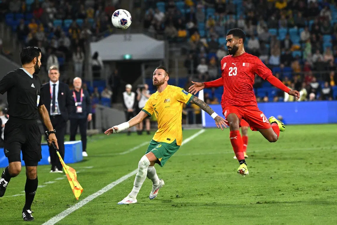 Australia's Martin Boyle and Abdulla Al-Khulasi of Bahrain during their World Cup qualifier on Sept 5. The Australians lost 1-0 and will be aiming to bounce back in their next match, against Indonesia.