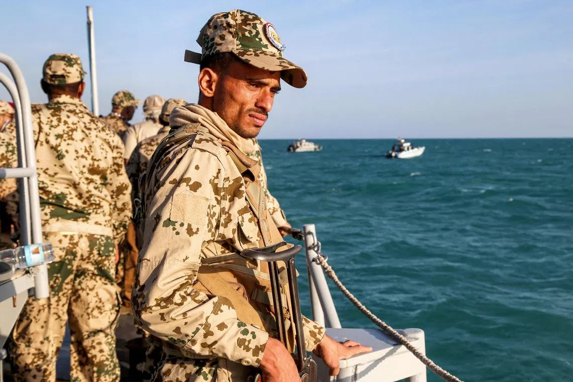 A Yemeni coastguard member rides in a patrol boat in the Red Sea on December 12, 2023. 