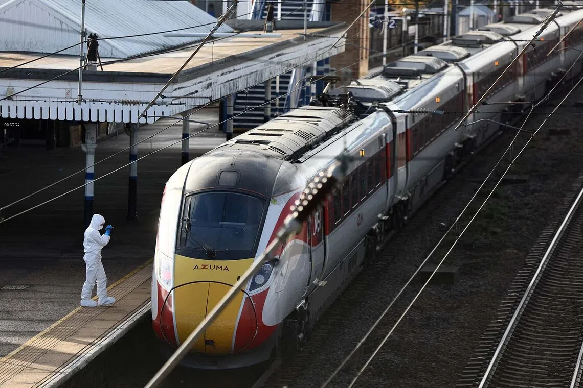 A forensic officer inspecting the London North Eastern Railway train where a series of stabbings took place, at a platform at Huntingdon Station, near Cambridge, Britain, Nov 2, 2025. 