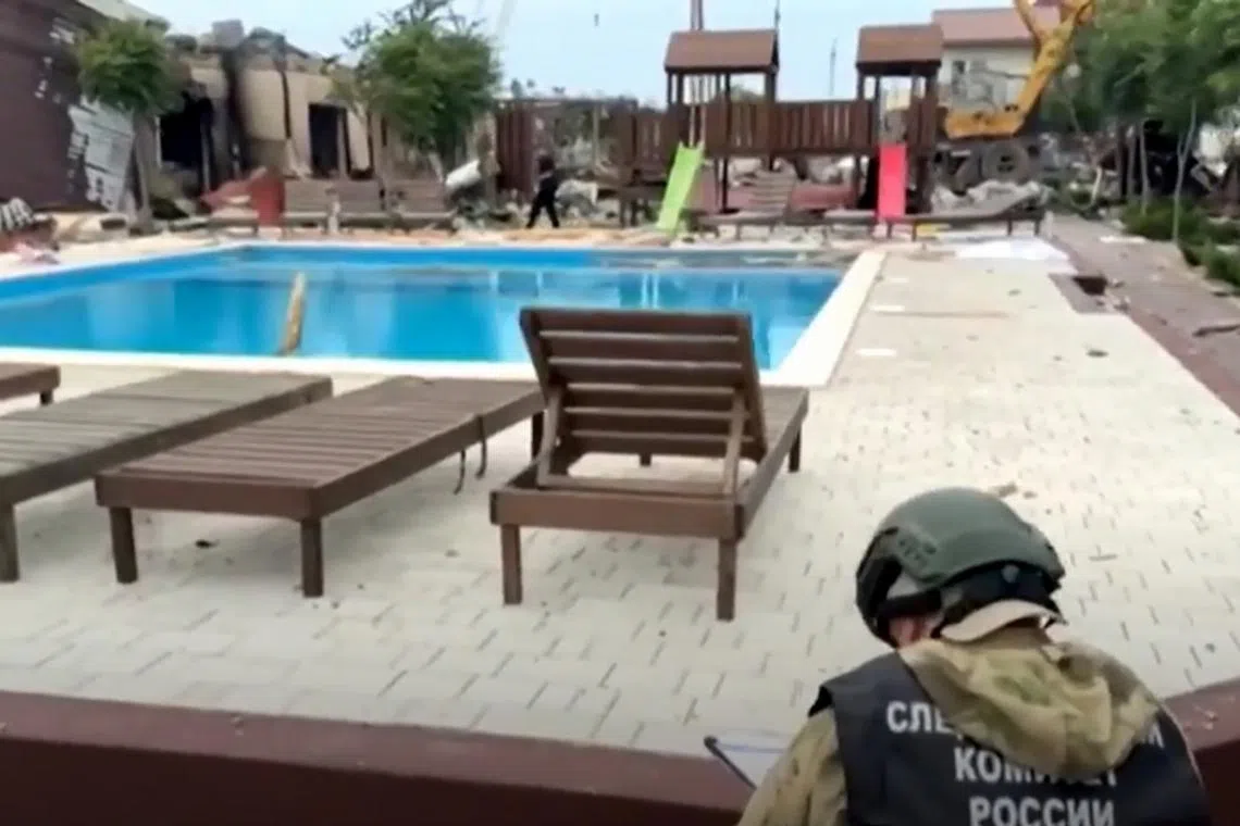 A screengrab from a video posted online of a holiday camp site in the resort area of Kyrylivka, Ukraine, showing damaged buildings near a swimming pool.