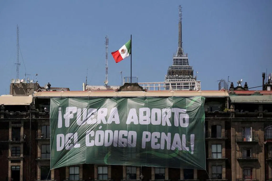 FILE PHOTO: A banner reading: \"Abortion Out of the Penal Code\" hangs from a building during International Women's Day, at the Zocalo Square in Mexico City, Mexico March 8, 2023. REUTERS/Quetzalli Nicte-Ha/File Photo