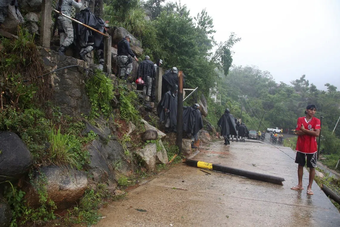FILE PHOTO: A resident stands near an area affected by a mudslide caused by Hurricane John, in Acapulco, Mexico September 26, 2024. REUTERS/Javier Verdin/File Photo