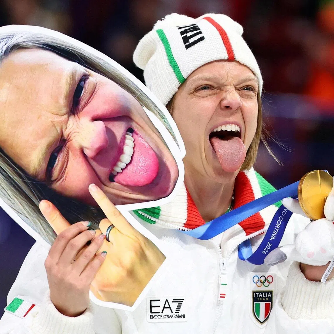 Gold medallist Arianna Fontana of Italy with her a cutout of her face as she celebrates on the podium after winning the mixed short track relay at the Milano-Cortina Winter Olympics on Feb 10, 2026.