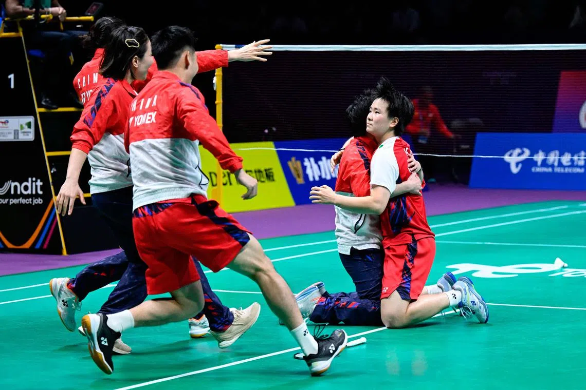 He Bingjiao celebrating with teammates after securing the Uber Cup for China with her victory over Indonesia's Ester Nurumi Tri Wardoyo in Chengdu on May 5, 2024.
