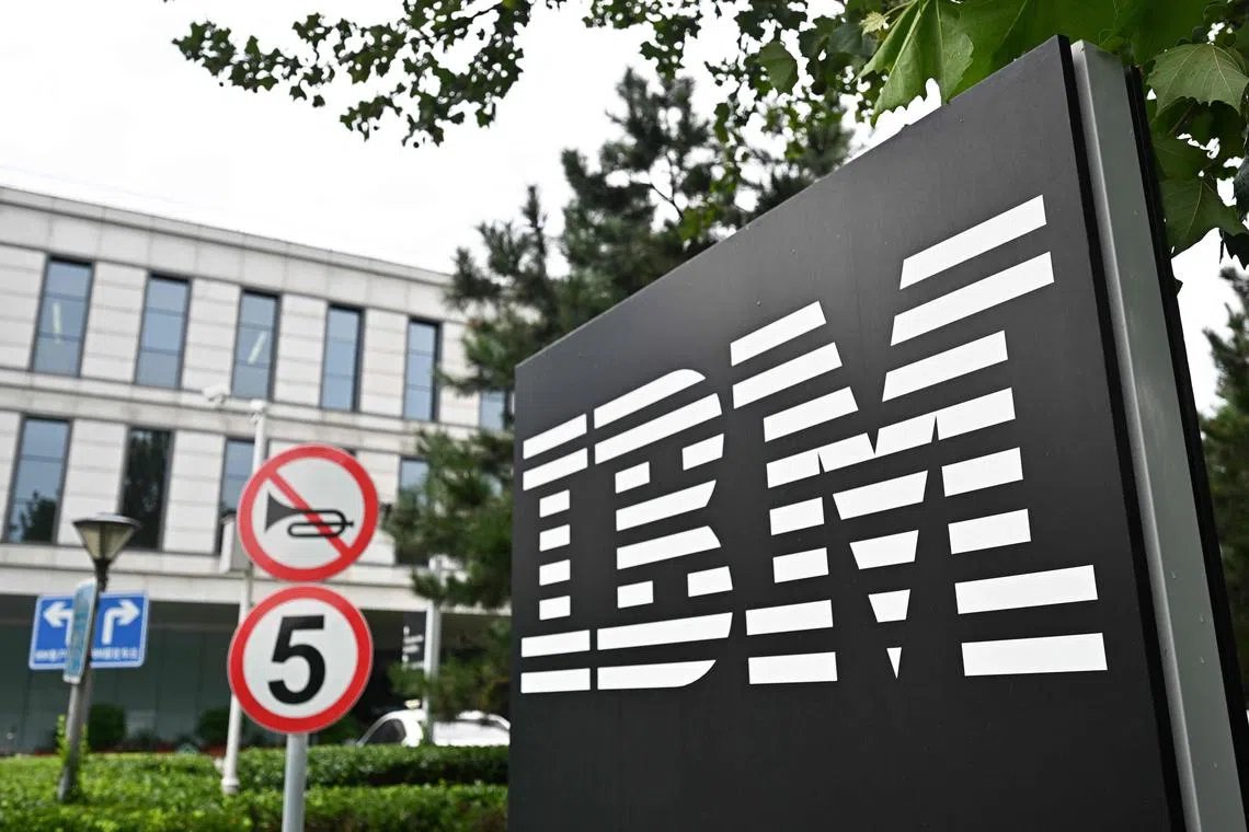 The IBM logo is seen at the entrance to its China System Center building in Beijing on August 26, 2024. US computer giant IBM will eliminate over a thousand jobs in its research and development arm in China, multiple employees told AFP on August 26. (Photo by Pedro PARDO / AFP)
