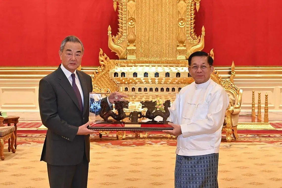This photograph taken on August 14, 2024 and released by the Myanmar Military Information Team shows Myanmar's military chief Min Aung Hlaing (R) meeting with China's Foreign Minister Wang Yi in Naypyidaw. Myanmar's embattled junta chief and China's foreign minister on August 14 discussed security along their shared border where ethnic minority armed groups have captured territory from the Myanmar military in recent weeks, junta media said. (Photo by MYANMAR MILITARY INFORMATION TEAM / AFP) / RESTRICTED TO EDITORIAL USE - MANDATORY CREDIT "AFP PHOTO / Myanmar Military Information Team" - NO MARKETING NO ADVERTISING CAMPAIGNS - DISTRIBUTED AS A SERVICE TO CLIENTS