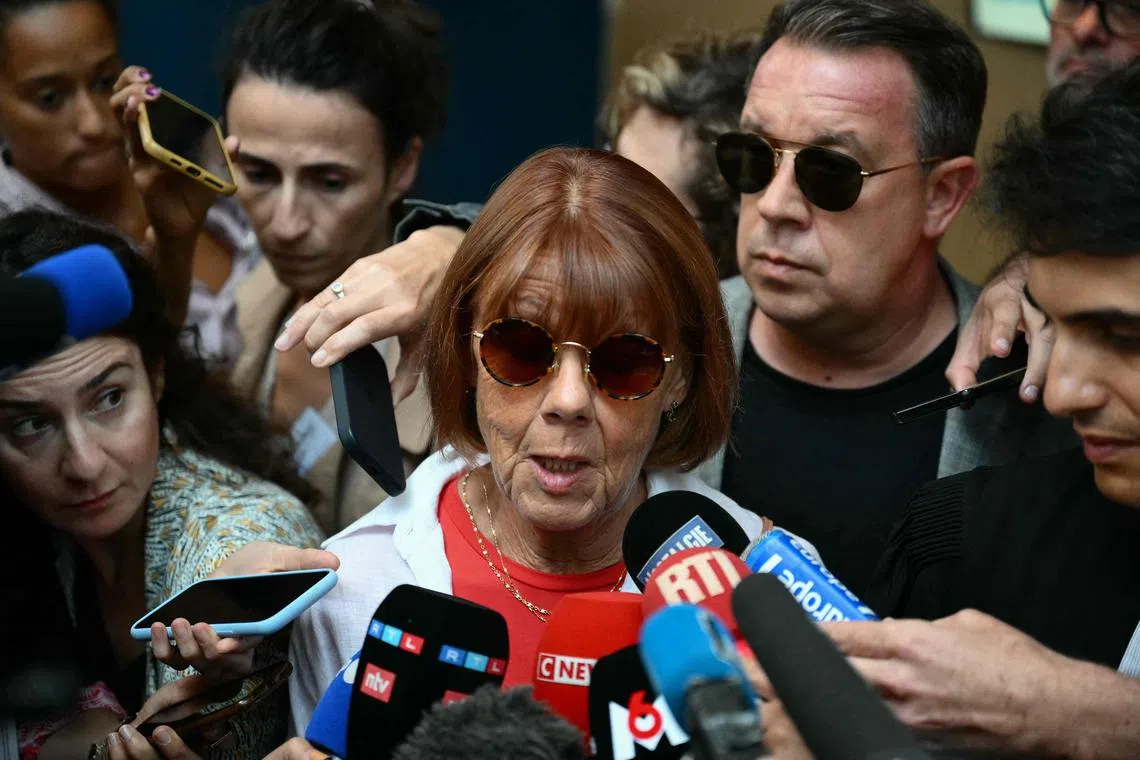 Gisele P, escorted by her lawyer and one of her sons, addressing the media as she leaves court on Sept 5.
