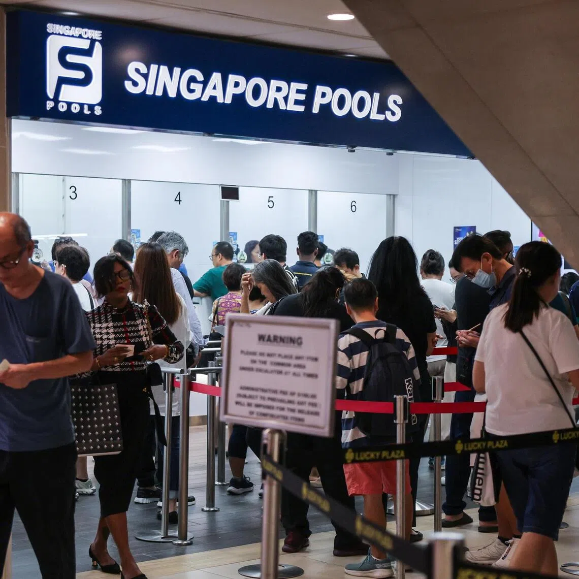 Punters queuing at a Singapore Pools branch in Lucky Plaza on Nov 6.