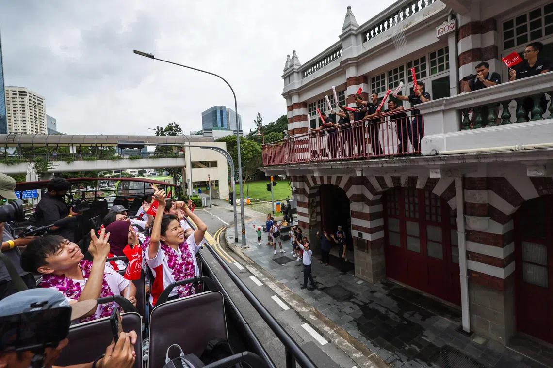 Double gold medallist and para swimmer Yip Pin Xiu showing her love for Team Singapore’s supporters during the open-top bus parade for the 10 athletes who took part in the Paris Paralympics. About 3,000 supporters turned out to cheer on the para-athletes at four 'cheer' points and along the route, including a group of firefighters at the Central Fire Station on Hill Street on September 16, 2024. 