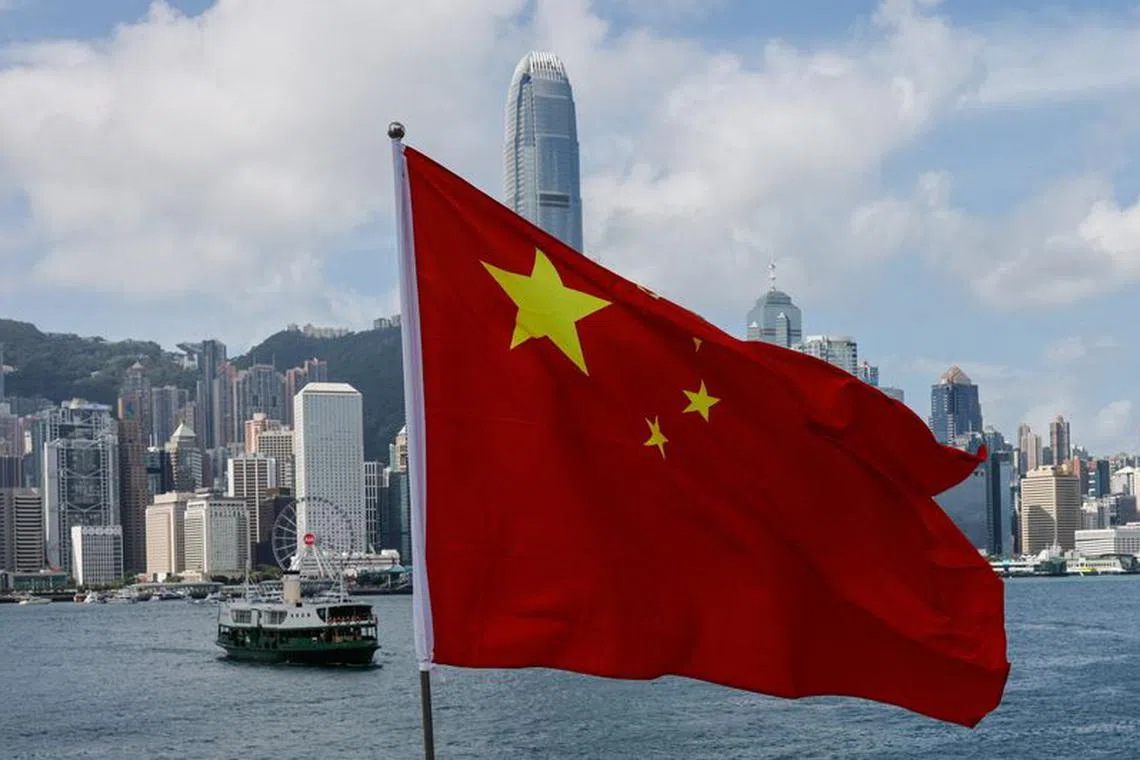 FLIE PHOTO: The Chinese national flag is seen in front of the financial district Central on the Chinese National Day in Hong Kong, China October 1, 2022. REUTERS/Tyrone Siu/file photo