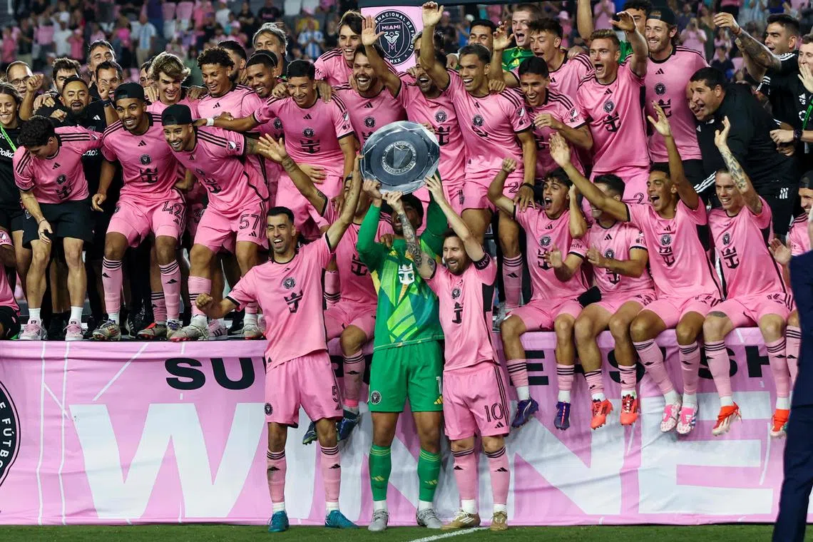 Inter Miami's Spanish midfielder Sergio Busquets (No. 5), Uruguayan forward Luis Suarez (No. 9), US goalkeeper Drake Callender (No. 1) and Argentinian forward Lionel Messi (No. 10) holding the Supporters' Shield after the Major League Soccer football match against New England Revolution at Chase Stadium in Fort Lauderdale, Florida on Oct 19.