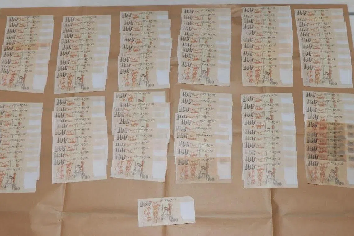A search revealed 121 counterfeit Singapore $100 notes in the duo’s possession.